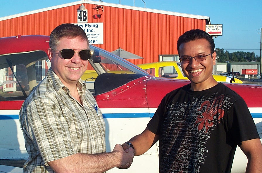 Aaron Pinto with Pilot Examiner Jim Scott after the successful completion of Aaron's Private Pilot Flight Test on July 22, 2008. Langley Flying School.