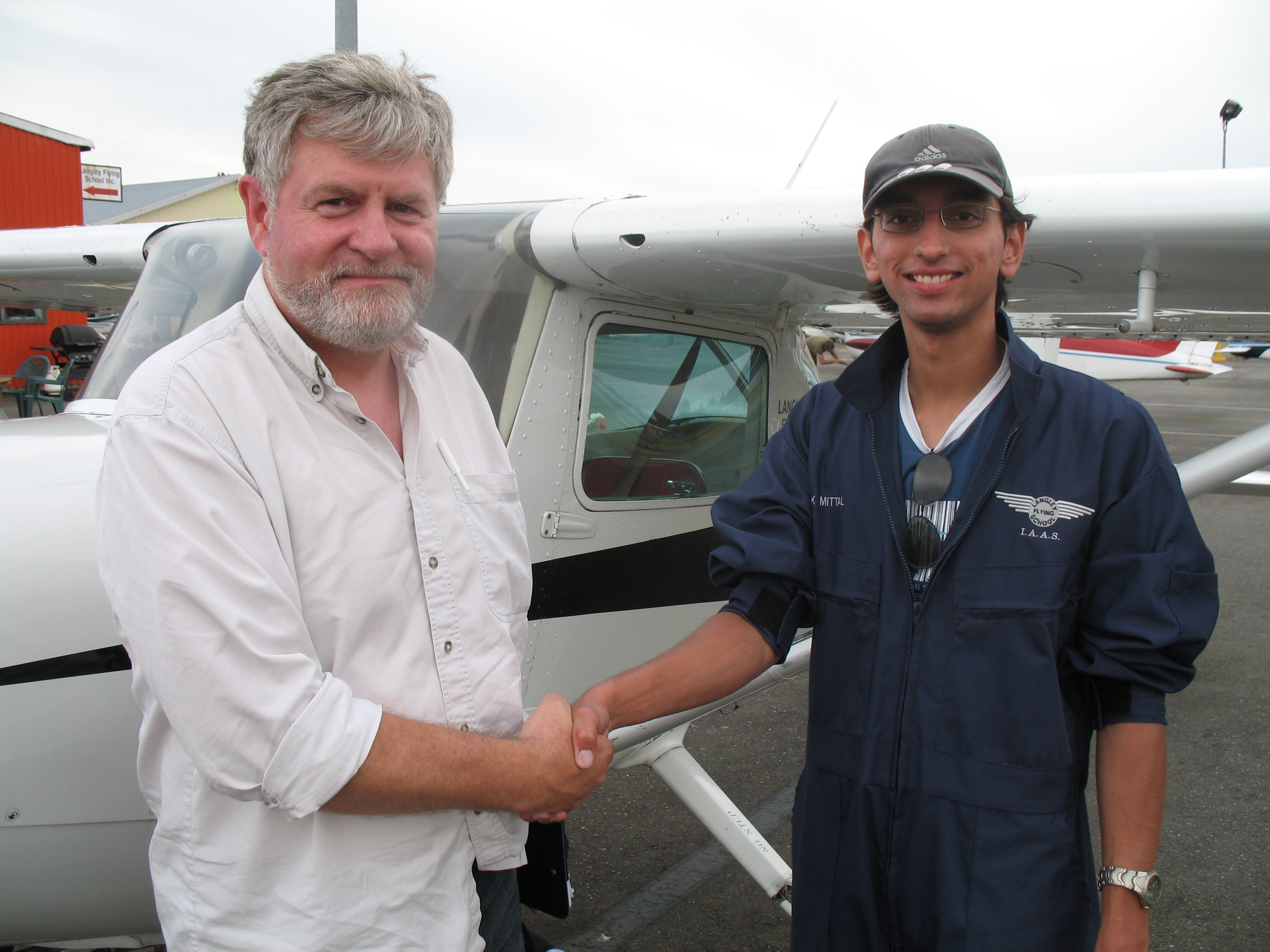 Mayank Mittal with Pilot Examiner Paul Harris after the successful completion of Mayank's Commercial Pilot Flight Test. Langley Flying School.
