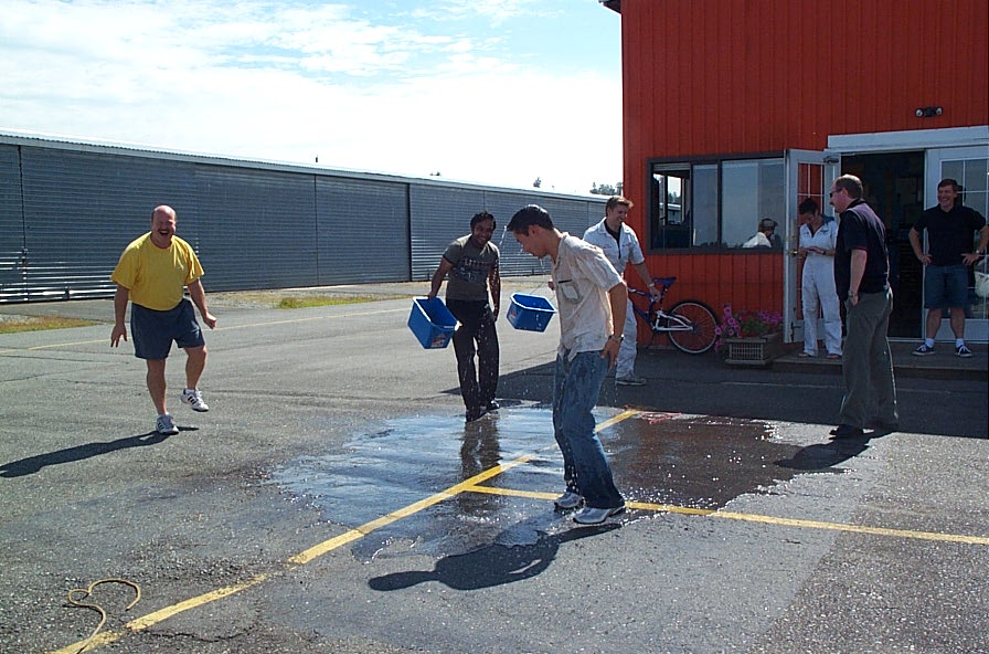 Nam Vu with his Flight Instructor, David Parry, and Transport Canada Inspector Peter Cox.  Phil Craig and Aniket Chavan do the bucket deed, with Flight Instructor Naomi Jones and Peter Waddington look on.  Langley Flying School.