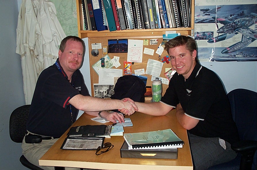 Philip Craig receives congratulations from Pilot Examiner Peter Cox after the successful completion of the qualiflying Flight Test for Phil's Class II Flight Instructor Rating.