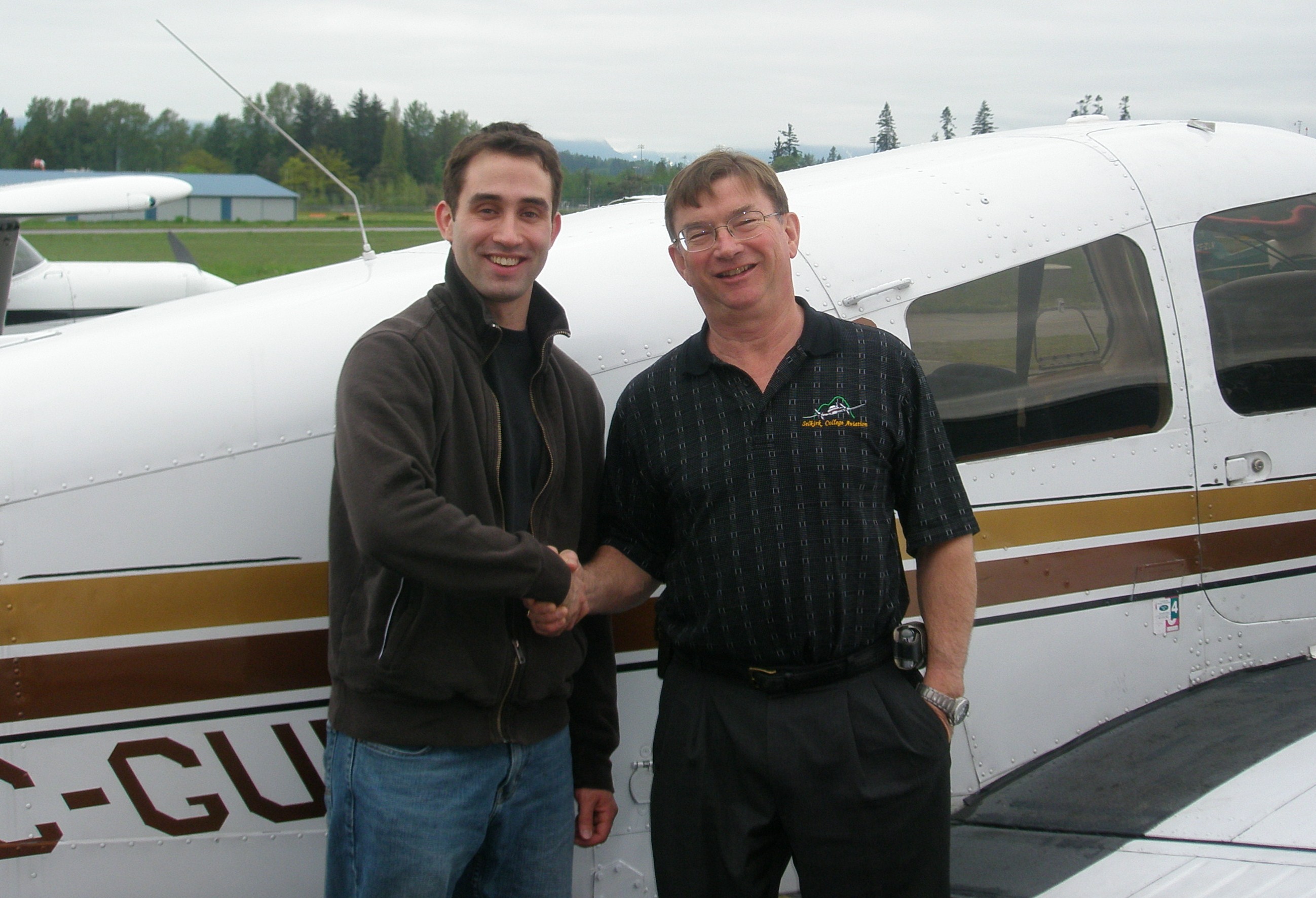 Shadrin Storness-Bliss with Pilot Examiner John Laing after the successful completion of Shad's Commercial Pilot Flight Test on May 15, 2008.  Langley Flying School