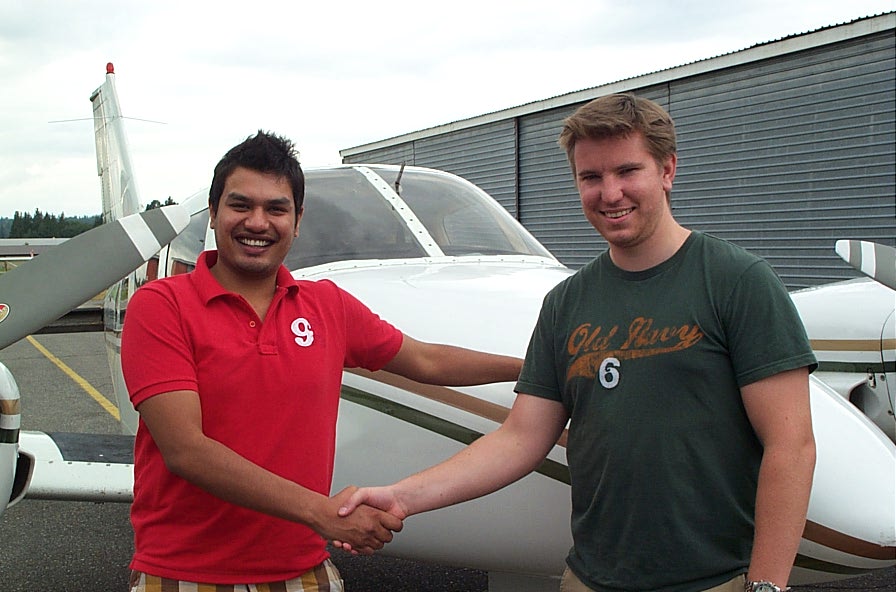 Commercial Pilot Vikas Choudhary receives congratulations from his Flight Instructor, Phil Craig, after the successful completion of his Multi-engine Class Rating on August 21, 2009 with Pilot Examiner Todd Pezer.  Langley Flying School.