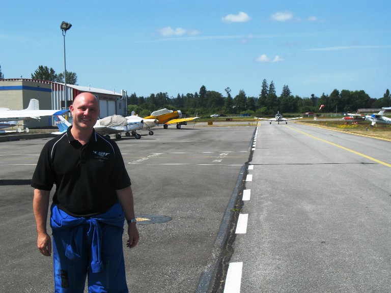 Flight Instructor Rod Giesbrecht waits after his student Ritesh Ahire taxies back follow his First Solo Release (x2).  Langley Flying School.