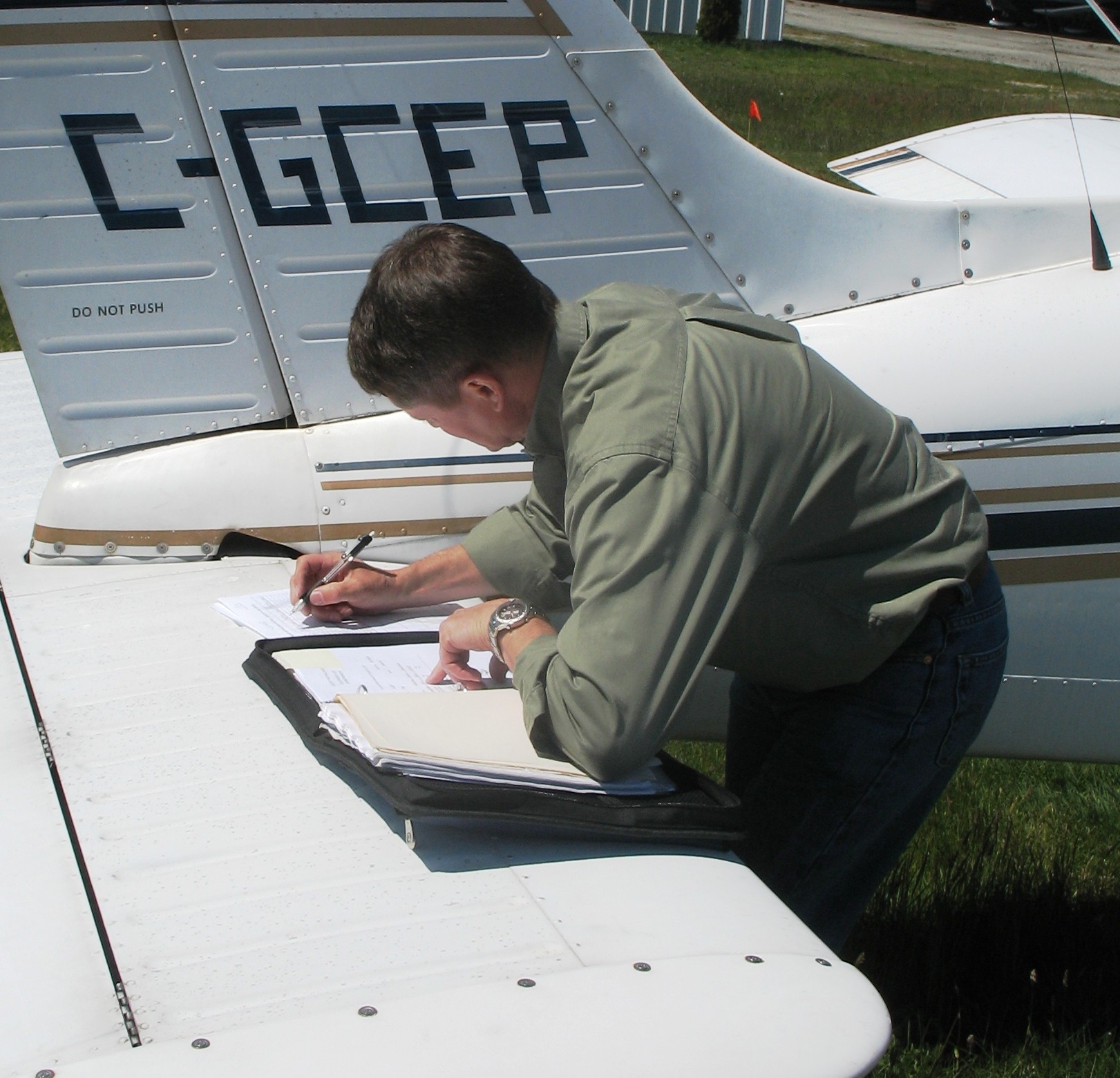 David Marshall updating his navigation log.  Langley Flying School.