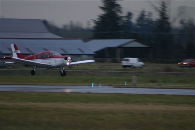 Piper Cherokee FKKF duirng landing flare onto Runway 01 at Langley Airport.  Langley Flying School.