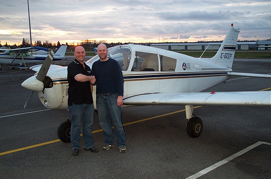 Carl Tingstad receives congratulations from his Flight Instructor, Rod Giesbrecht, after the successful completion of Carl's Private Pilot Flight Test.  Langley Flying School.