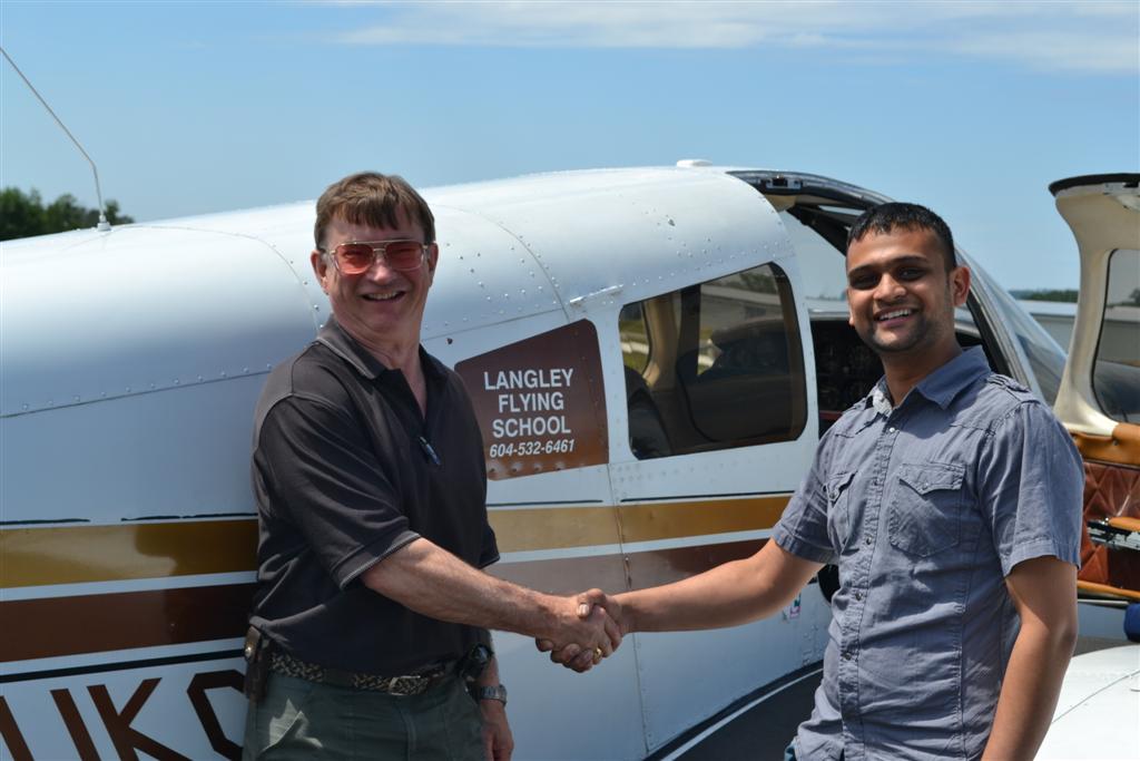 Ishan Patel receives contgratulations from his Pilot Examiner John Laing, after the successful completion of Ishan's Private Pilot Flight Test on July 2, 2011.  Langley Flying School.