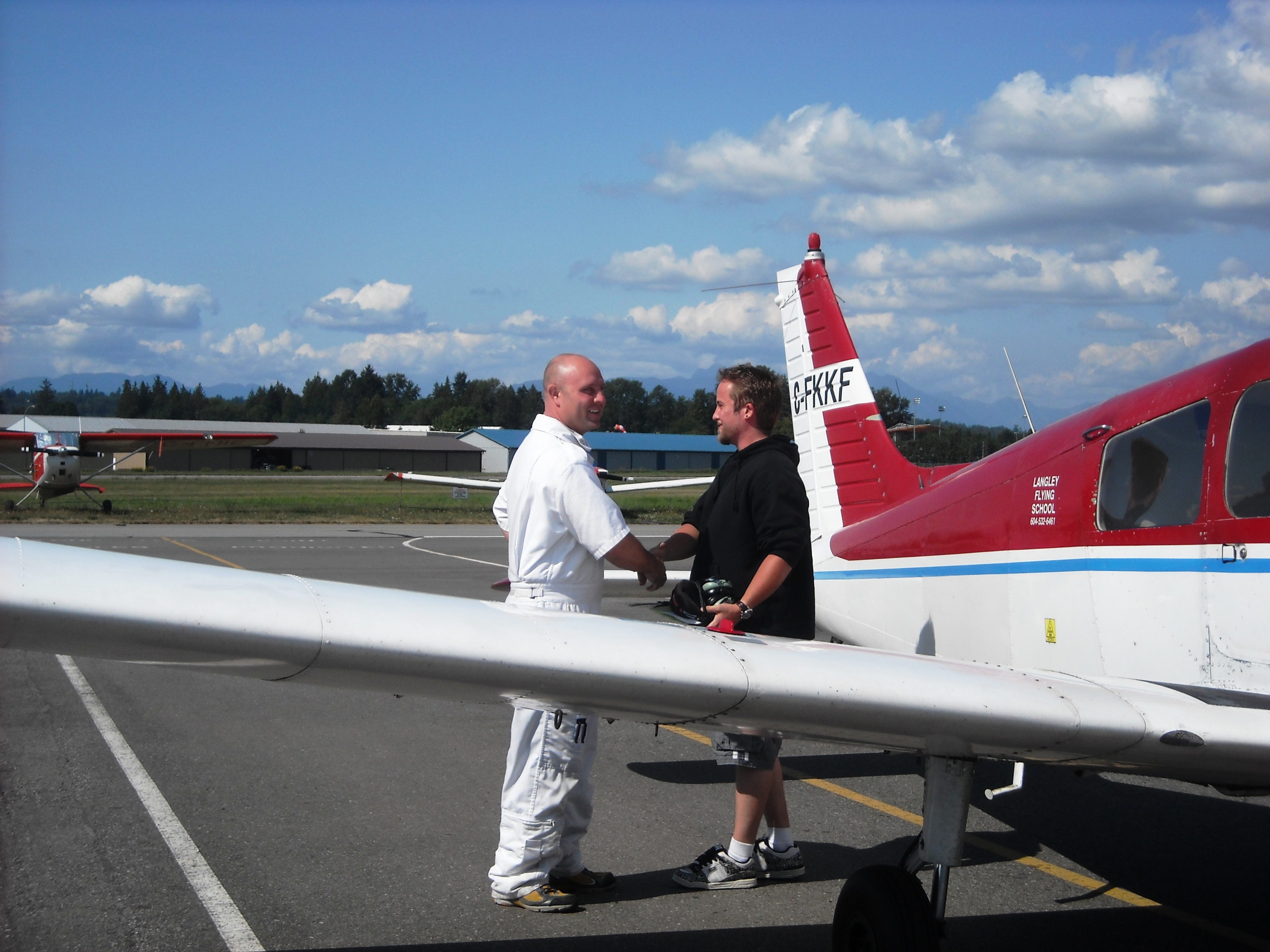 Private Pilot Student Jason Nel with Flight Instructor Rod Giesbrecht after the completion of Jason's Frist Solo Flight on August 22, 2009.  Langley Flying School.