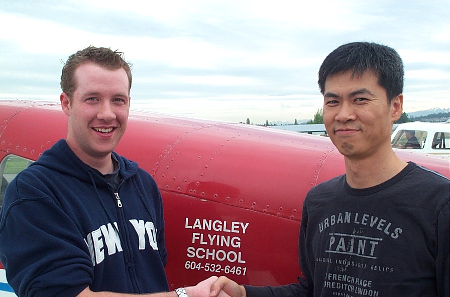 Kirk Palmer receives congratulations from Flight Instructor Hoowan Nam after the successful completion of Kirk's Private Pilot Flight Test on .  May 23, 2008.  Langley Flying School.