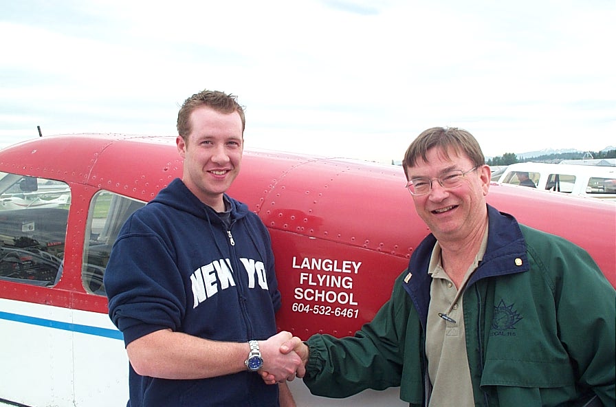 Kirk Palmer receives congratulations from Pilot Examiner John Laing after the successful completion of Kirk's Private Pilot Flight Test on May 23, 2008.  Langley Flyhing School.
