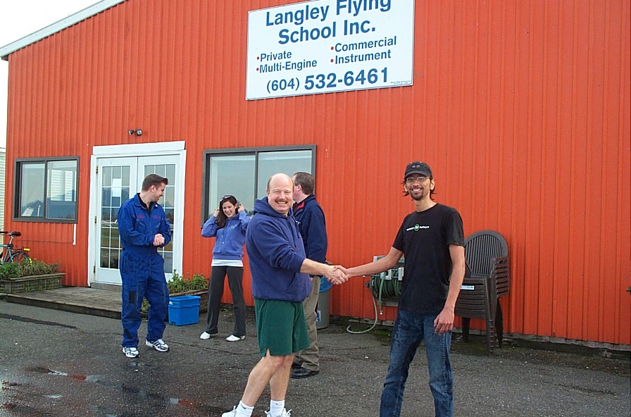 Mayank . . although wet . .  is congratulated by Dave Parry.  Langley Flying School.