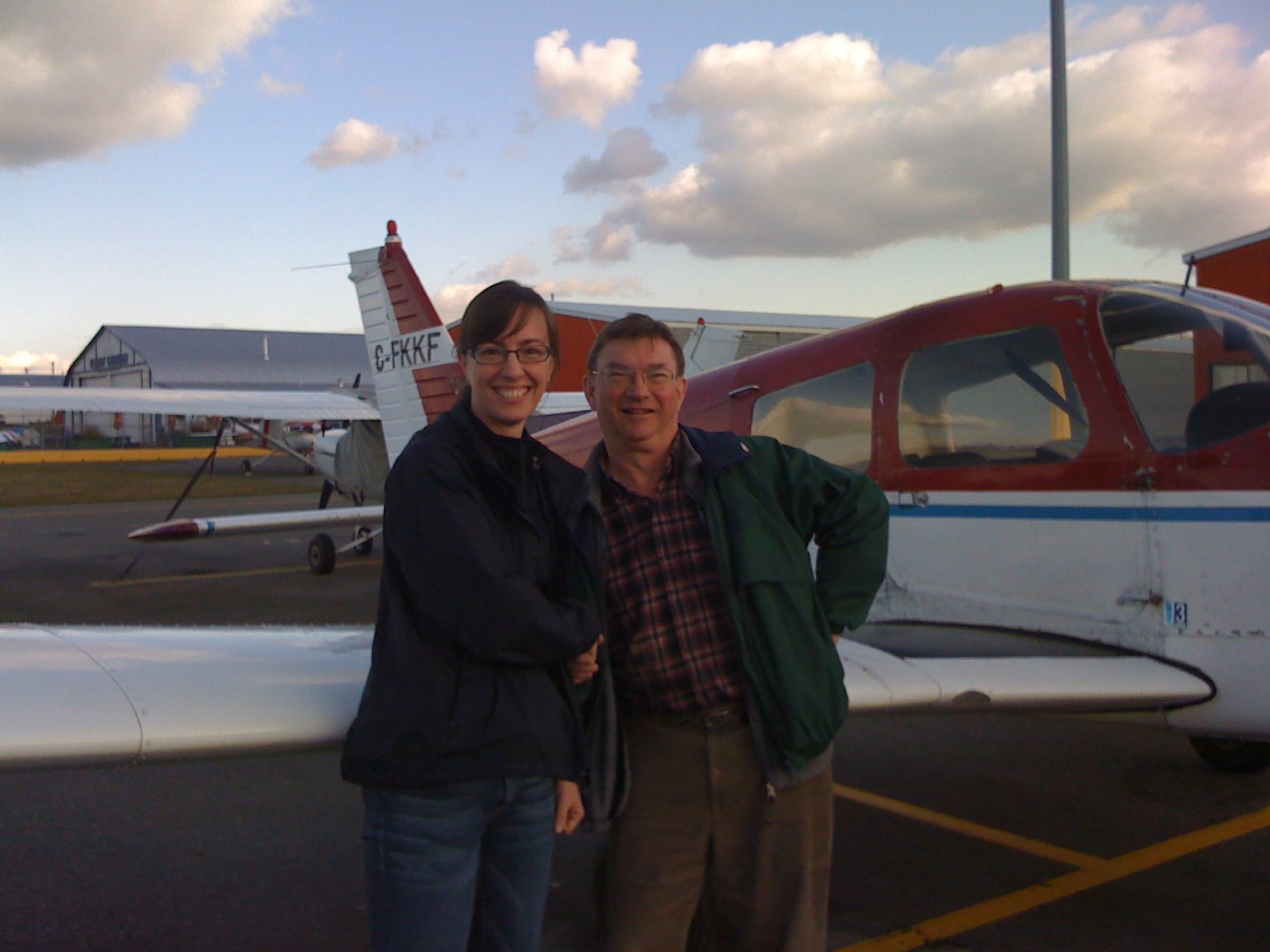 Michelle Thompson with Pilot Examiner John Laing after the completion of Michelle's Private Pilot Flight Test on October , 2009.  Langley Flying School.