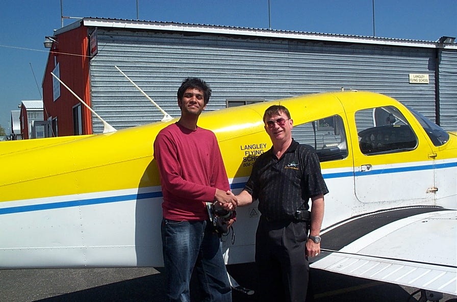 Suraj Canakapalli with Pilot Examiner John Laing after the successful completion of Suraj's Private Pilot Flight Test on May 15, 2008.  Langley Flying School.