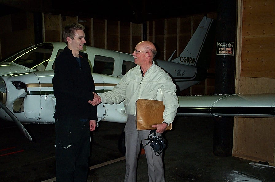 Tim Sawatzky receives congratulations from Pilot Examiner Donn Richardson after the completion of Tim's Multi-engine Class Rating Flight Test.  Langley Flying School.
