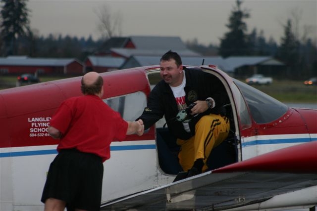 Chief Flying Instructor Dave Parry congratulates Stu Patterson upon completion of Stu's First Solo Flight. Langley Flying School.