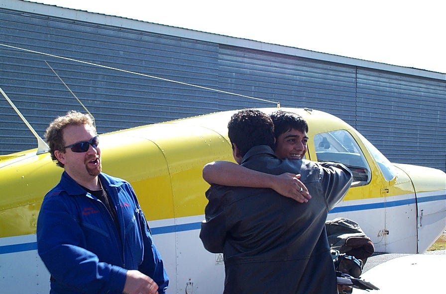 Nikhil Dongare receives contratulations from Pankaj Salve after the completion of Nikhil's First Solo Flight.  To the left is Flight Instructor Dave Page.  Langley Flying School.
